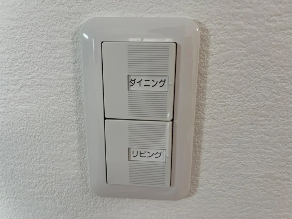 「ダイニング」「リビング」と表示された2連の照明スイッチ