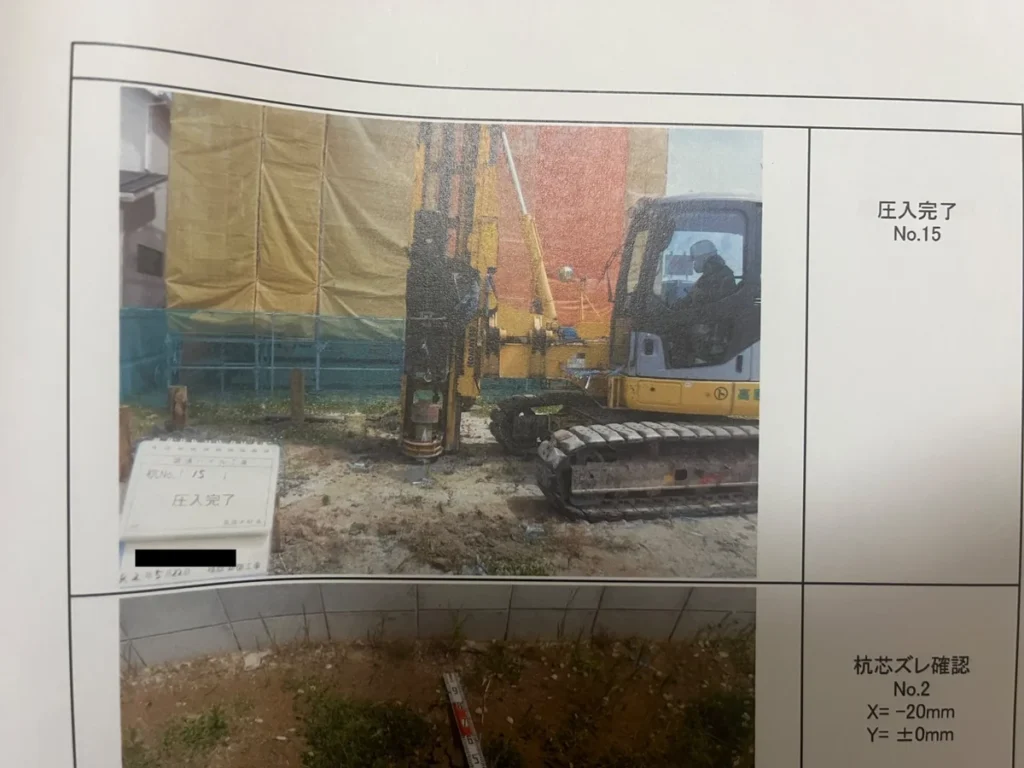 施工完了報告書の写真ページ。No.15の杭圧入完了とNo.2の杭芯ズレ確認を記録している